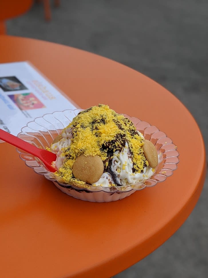 A dish of ice cream shaped like spaghetti, known as Eis, with cookies on top.