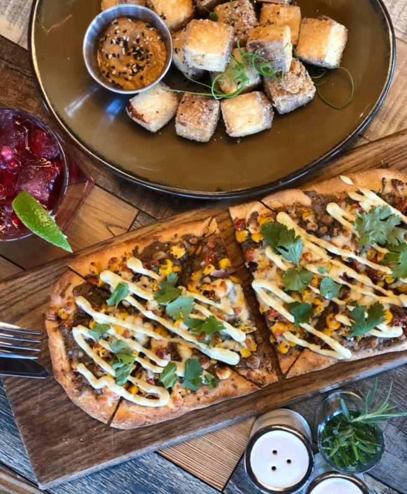 Sixty-Six Acres crispy Tofu Bites with Thai satay dipping sauce and Southwest Black Bean & Corn Flatbread with fire roasted corn salsa, cotija cheese & avocado crema