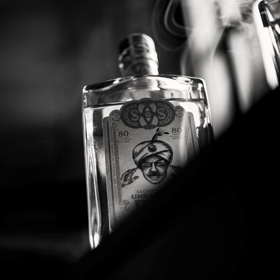 A black and white photo of Second Sight Spirit's rum, obscured by shadow.