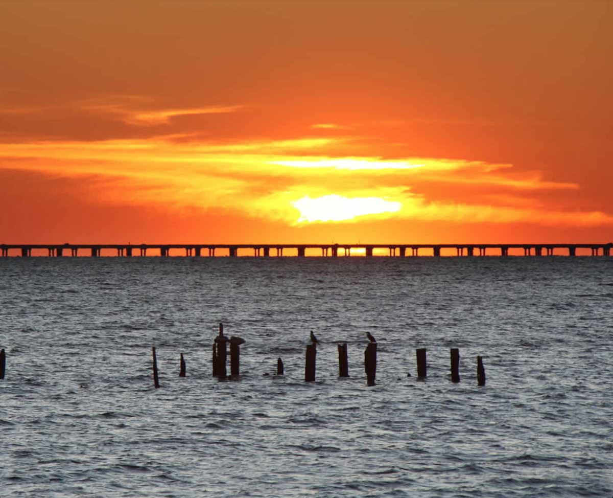 The sun sets on Lake Pontchartrain Causeway. This bridge has the potential to produce a state record trout on any given day.