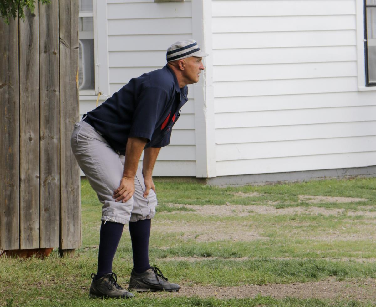 A gloveless fielder or ballist stands at the ready during a vintage base ball game on Mackinac Island