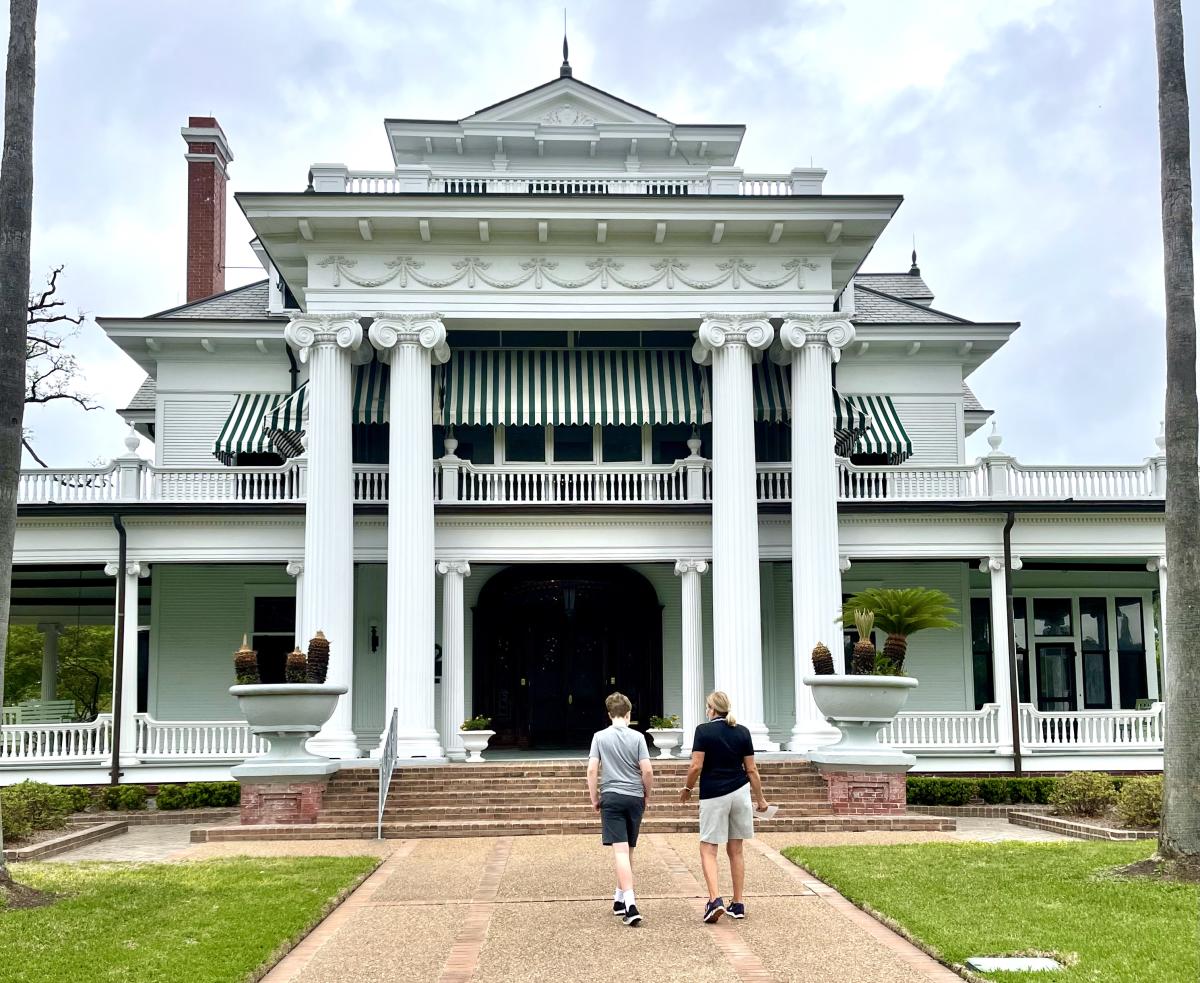 Two People Walking Up To The The McFaddin-Ward House In Beaumont, TX