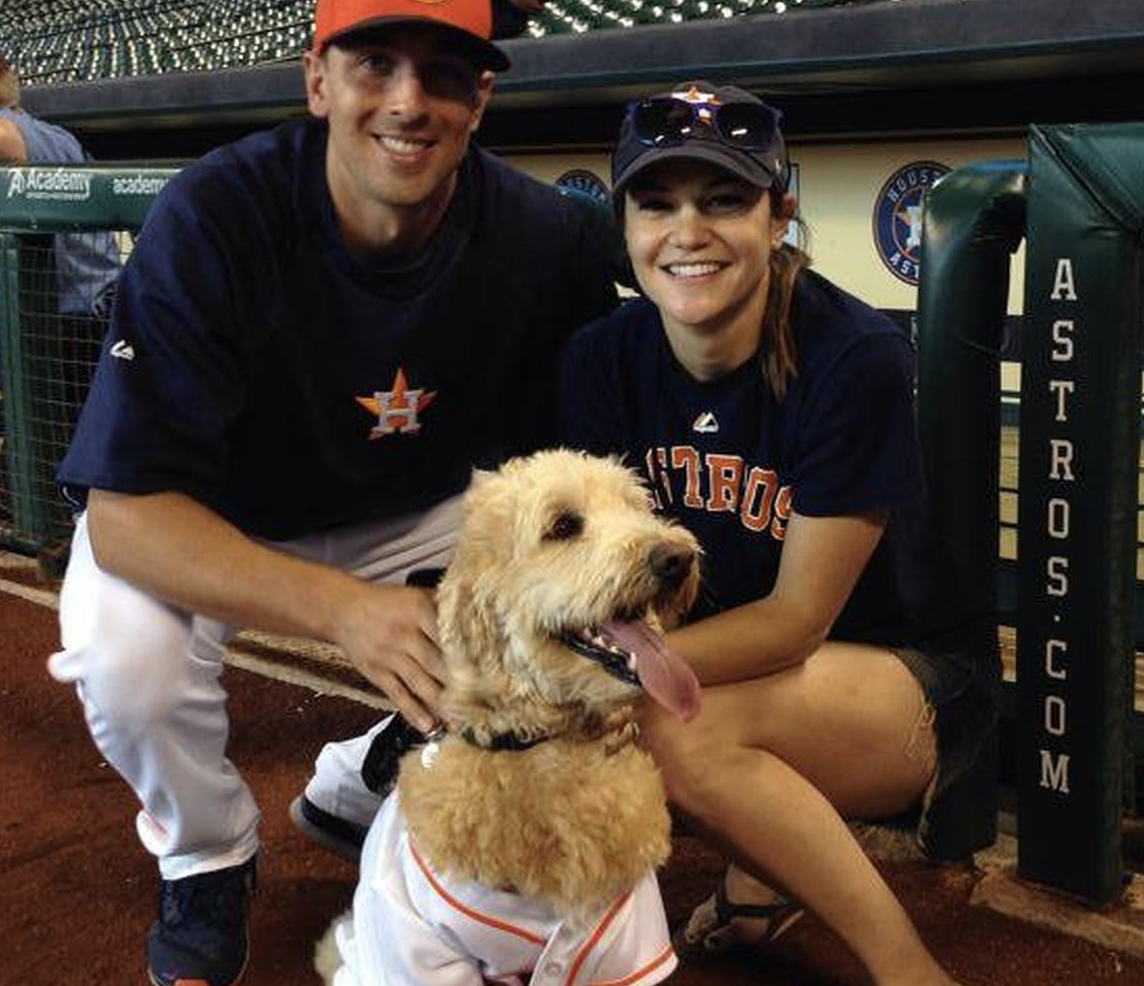 Man, Dog And Woman Posing At Dog Day at Minute Maid Park In Houston, TX
