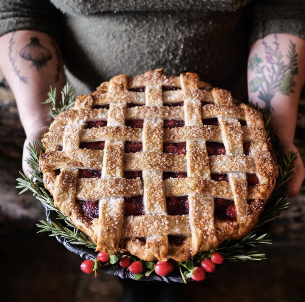 Woman's hands holding a lattice top holiday pie