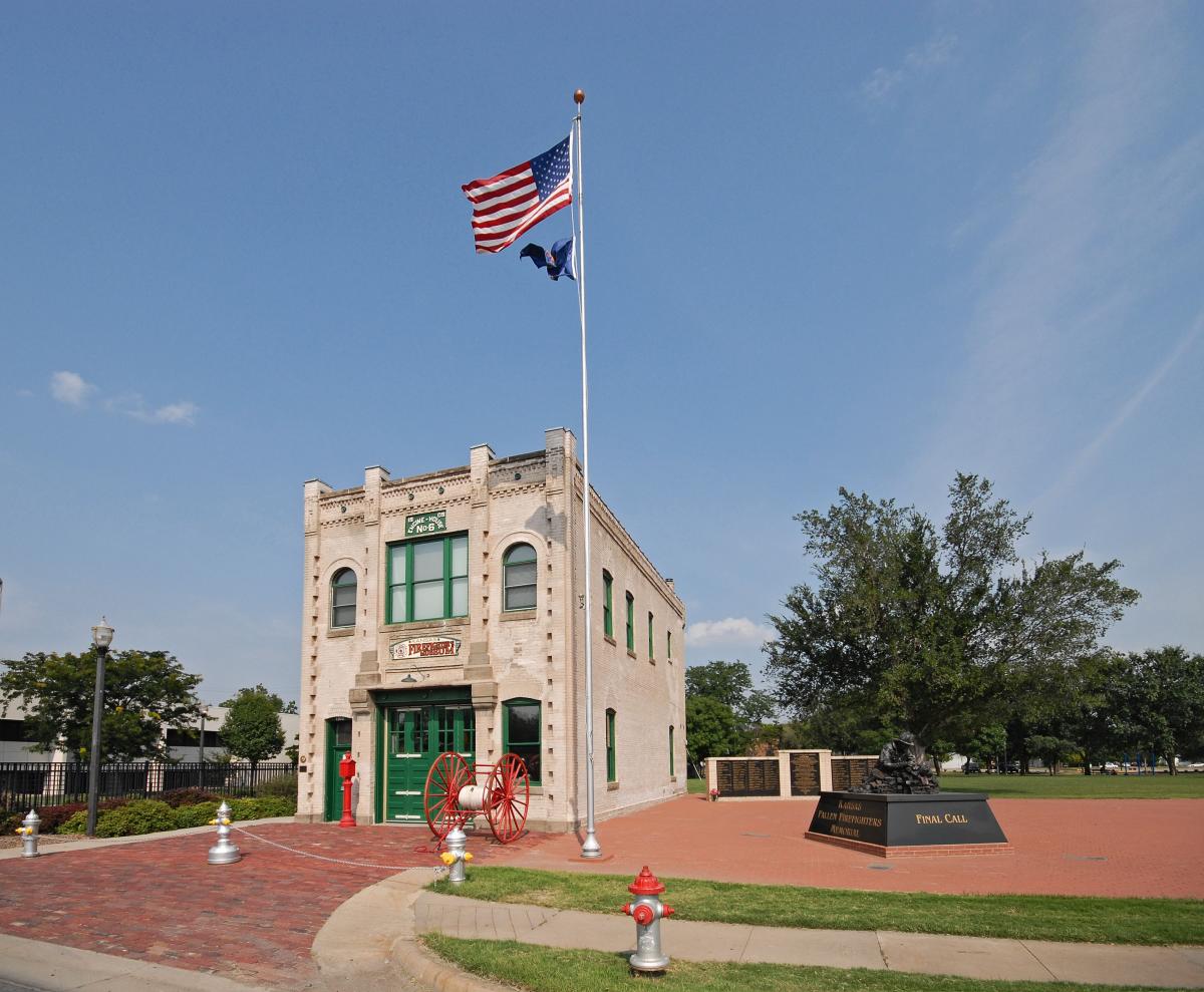 A flag waves in the breeze on a sunny day outside the Kansas Firefighters Museum.