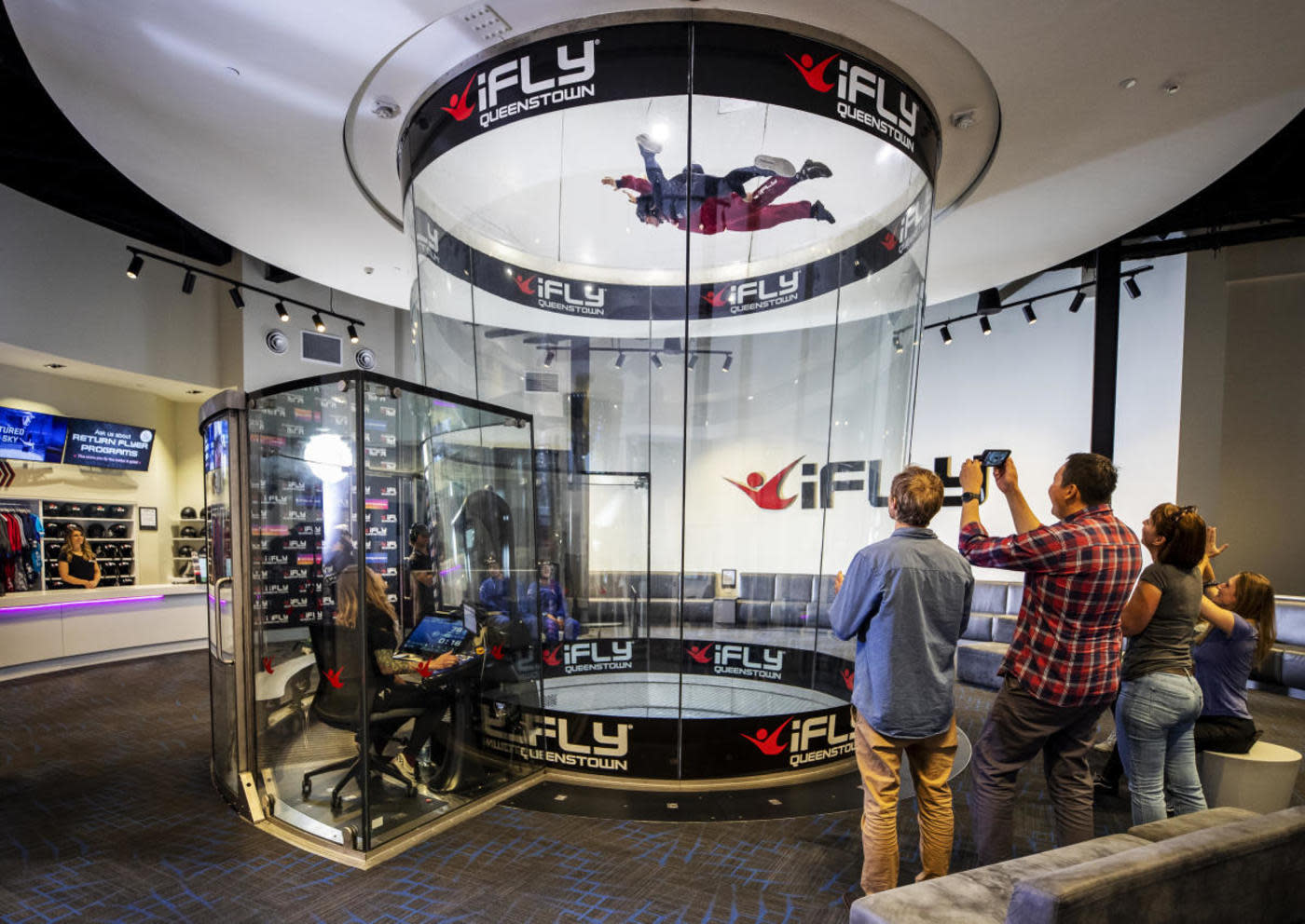 People spectating at indoor skydiving facility in Queenstown