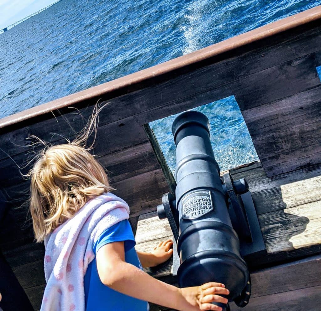 A child pretends to fire a cannon on the Mackinac Island Ferry Company's pirate ship cruise