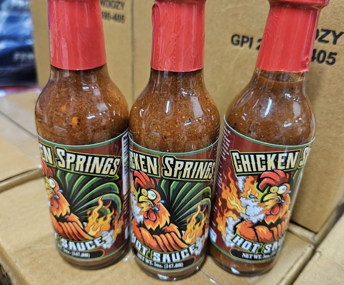 Photo of three hot sauce bottles on boxes