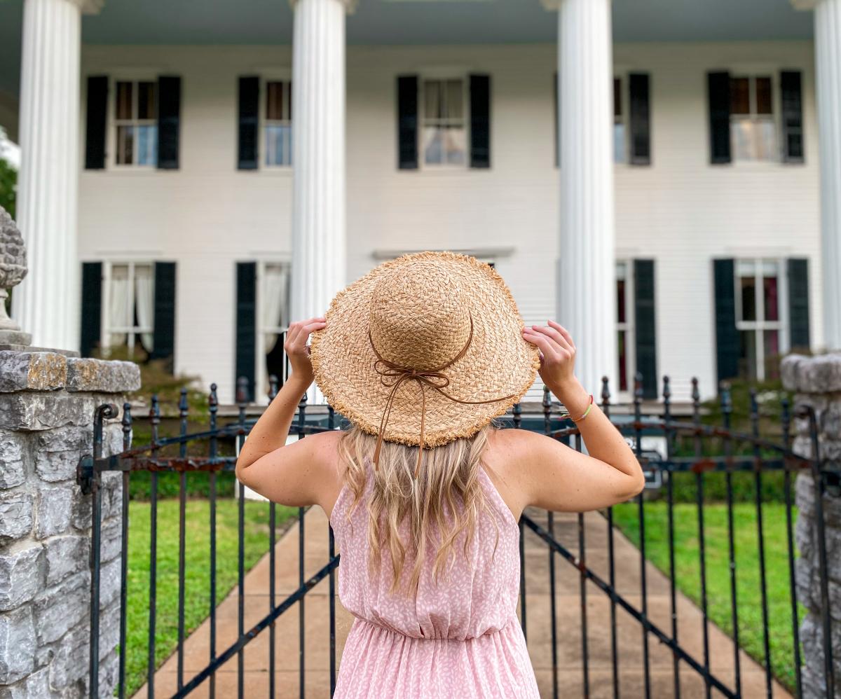 Woman looking at a historic home in Milledgeville, GA