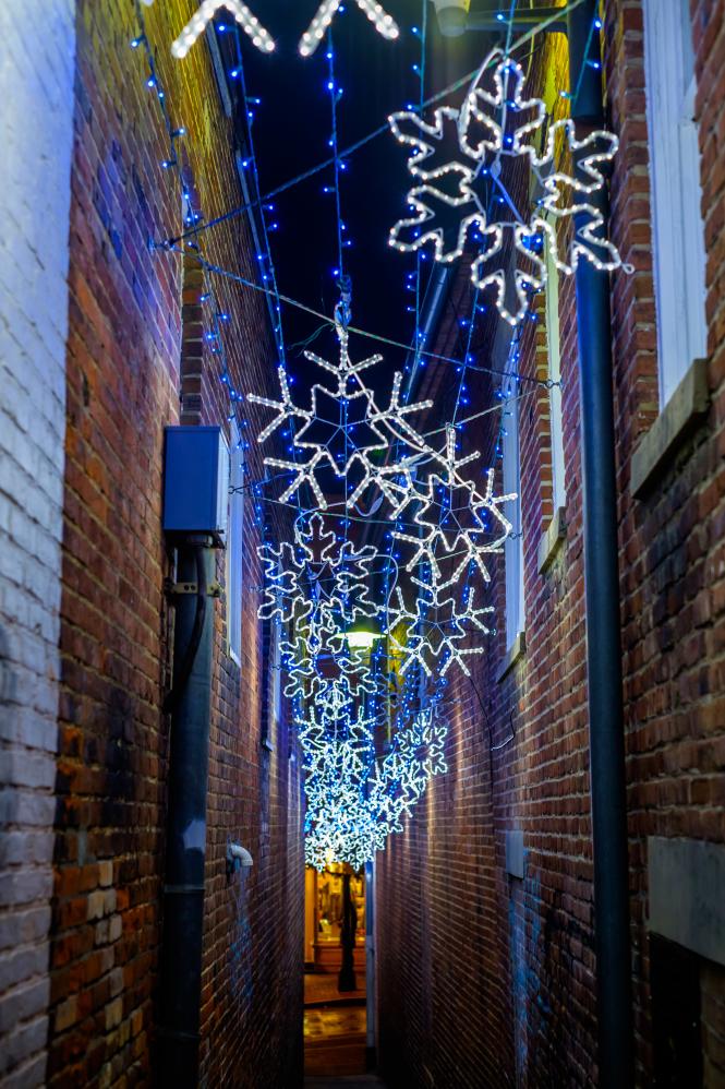 Christmas lights illuminating a dark alleyway in Annapolis