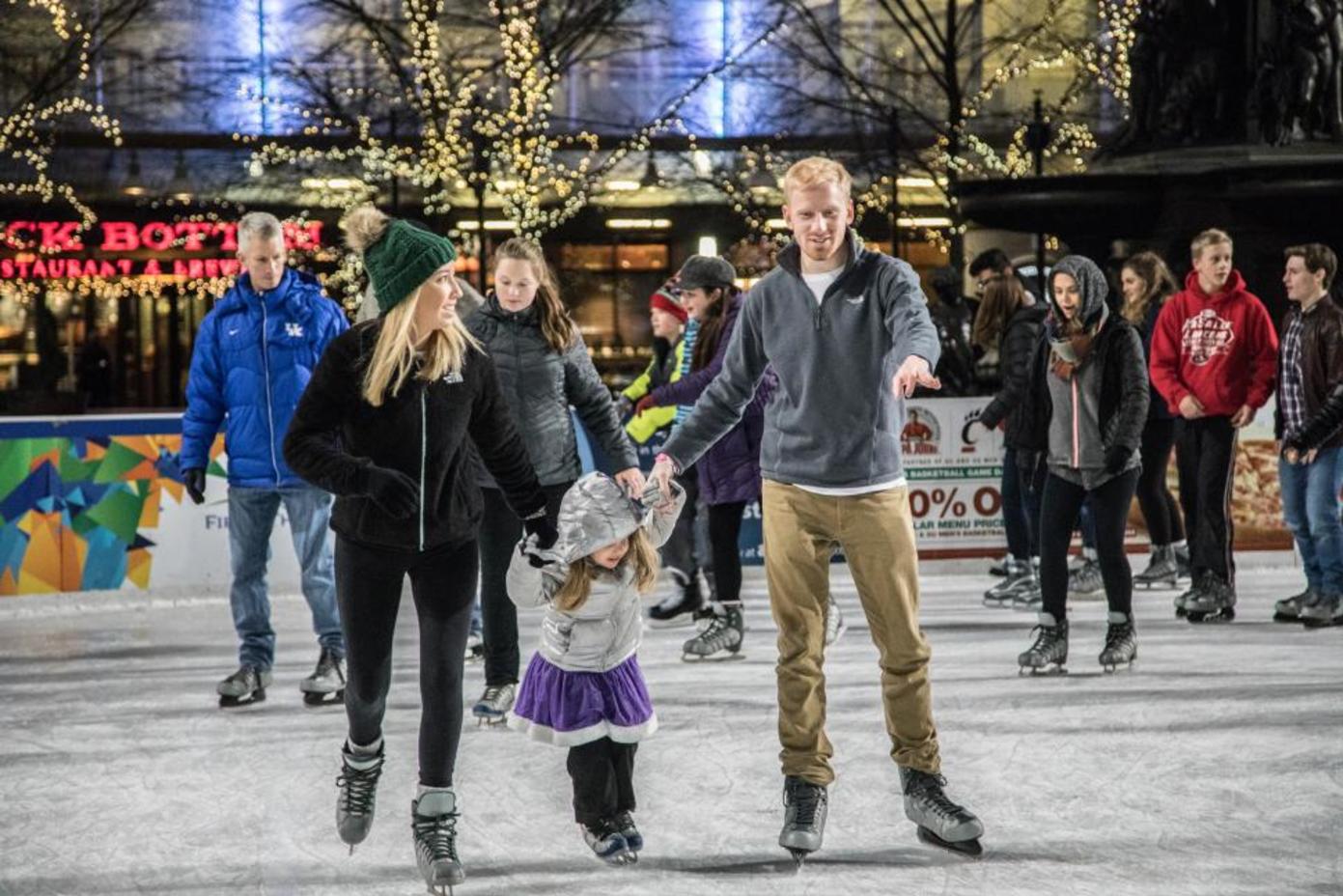 Family of three ice skating on Fountain Square (photo: CincinnatiUSA.com)