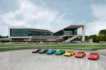 Porsche cars lined up in rainbow order outside of the Porsche Experience Center Atlanta.