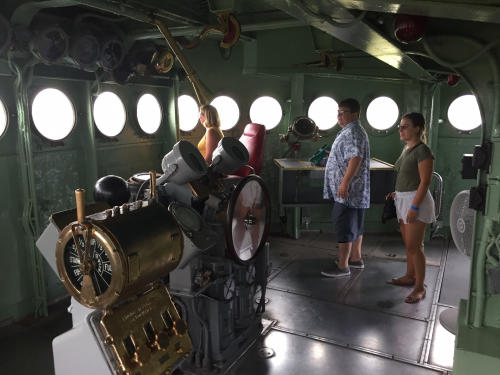 Bridge section of Battleship NORTH CAROLINA with people looking out the round windows