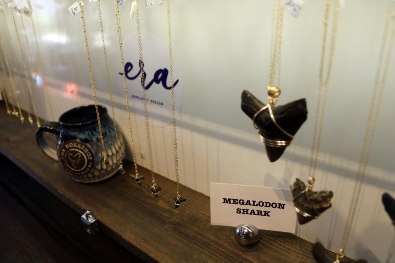 Megalodon Tooth Necklace and jewelry hanging at the Workshop