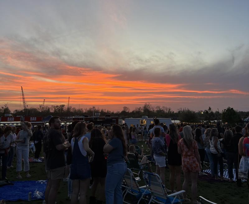 orange sunset during a concert at Live Oak Bank Pavilion