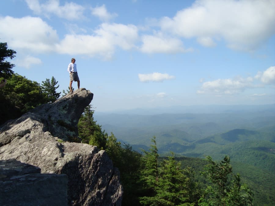 A man stands on The Blowing Rock overlooking Johns River Gorge