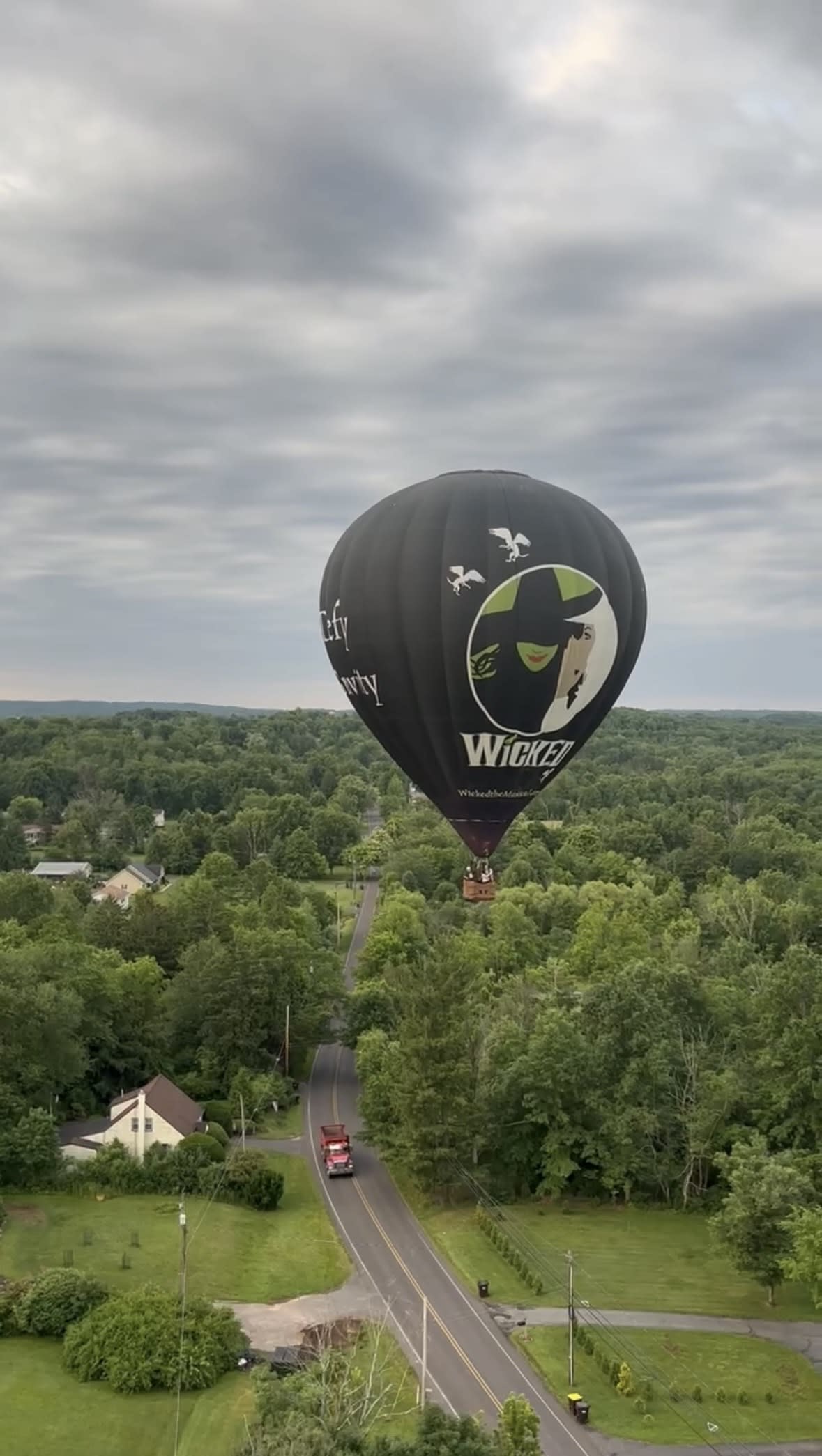 Hot air balloon flying over Lehigh Valley with musical Wicked logo displayed on balloon