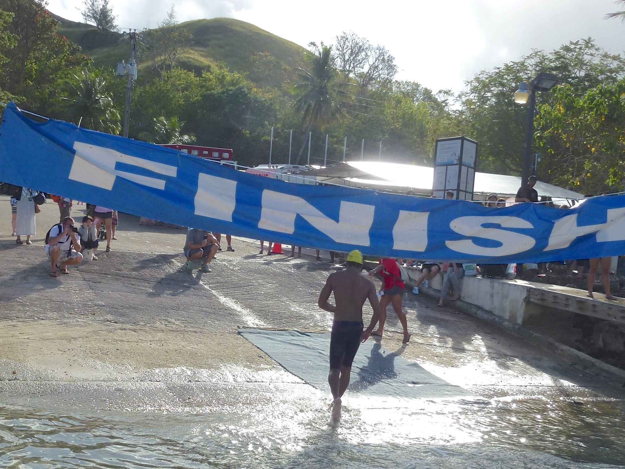 A swimmer crosses the finish line.
