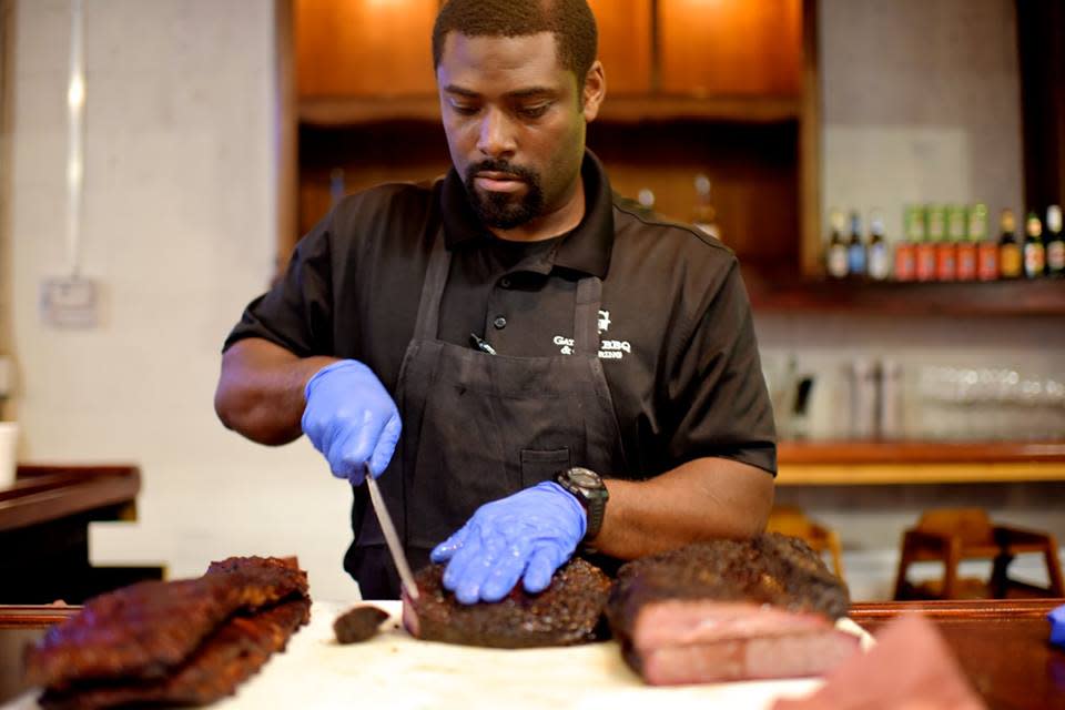 Chef cutting barbeque meat at Jackson St. BBQ