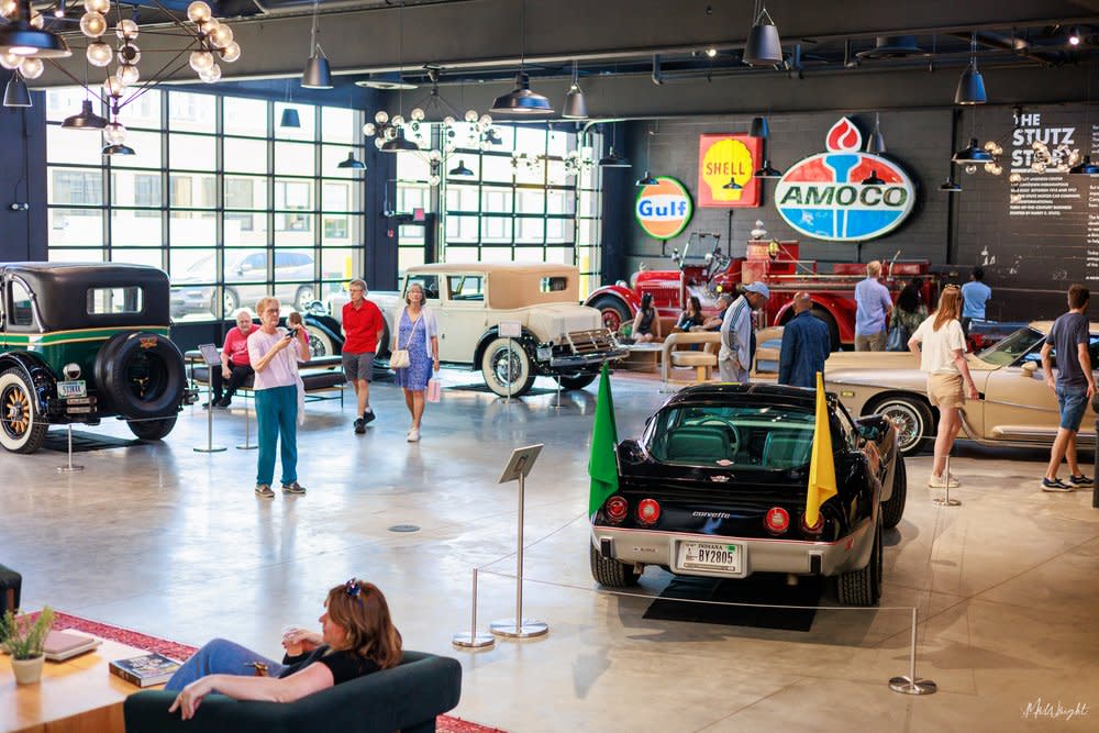 People Walking Around A Showroom at Stutz Car Museum in Indianapolis