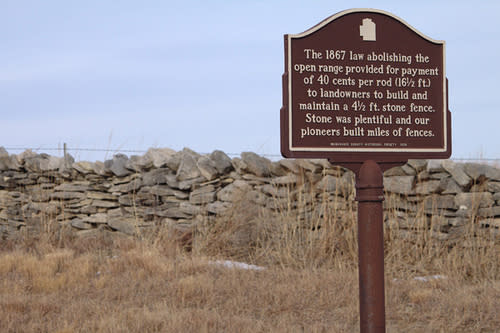 Limestone wall with historical sign 