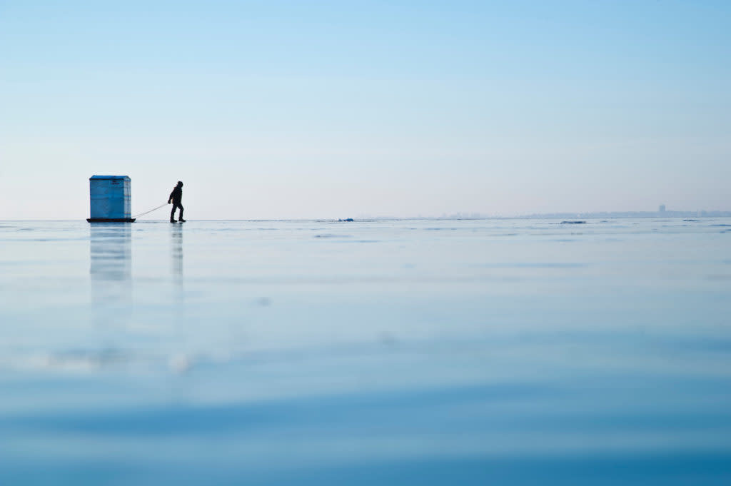 Ice fishing on frozen Little Bay de Noc on Lake Michigan in Gladstone Escanaba Michigan's Upper Peninsula.
