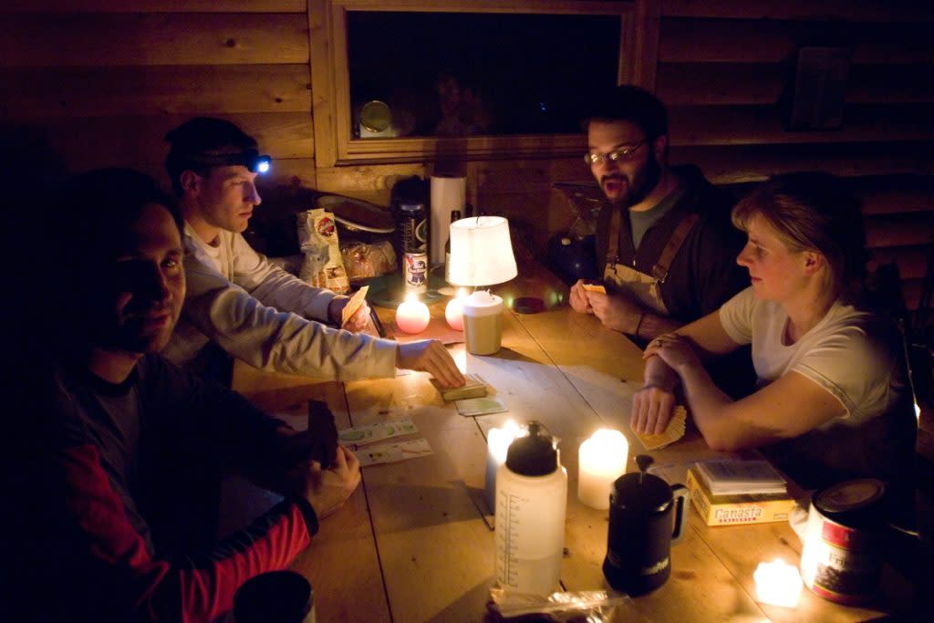 A group of friends play games while staying in a rustic cabin in Michigan's Upper Peninsula.