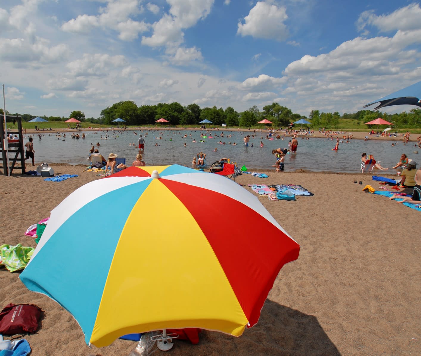 Umbrella on beach next to water