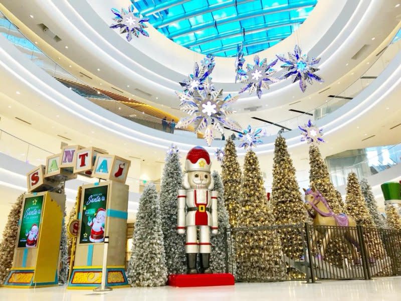 Holiday display at the Mall of America featuring a life-sized nutcracker standing in front of a row of Christmas trees