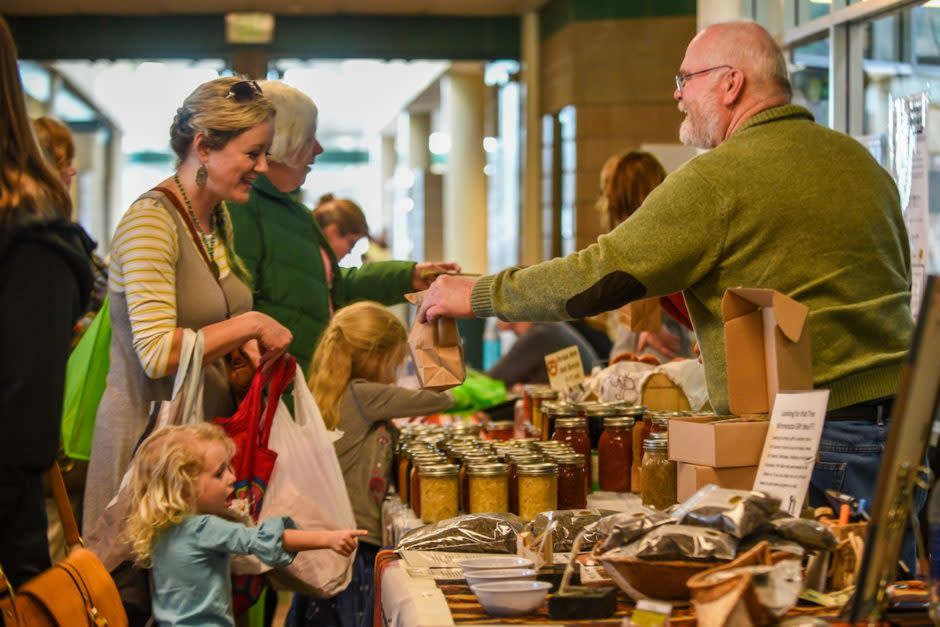 Customers buying goods at indoor farmer's market