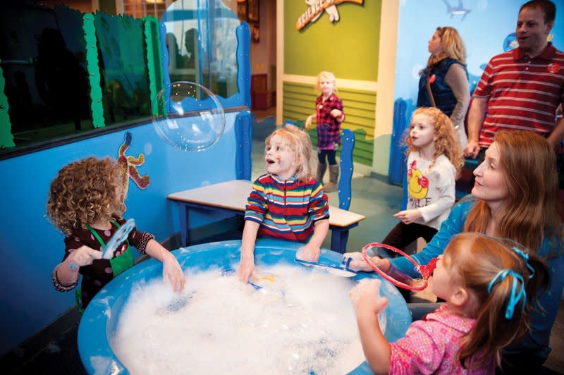 Children play in a tub of bubbles at the Minnesota Children's Museum