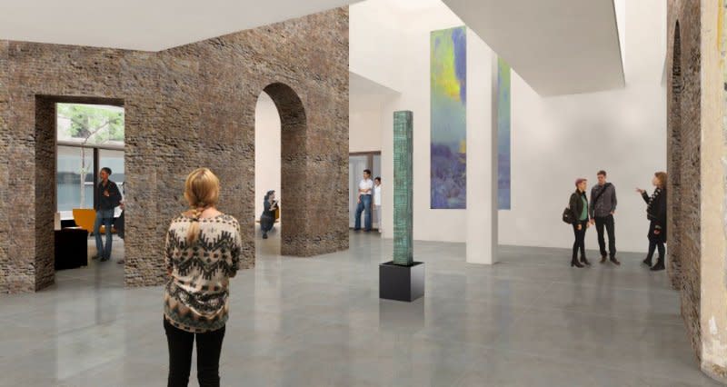 Various people stand in a large gallery space accented by stone arches at the Minnesota Museum of American Art