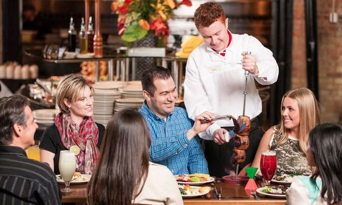 people eating at a Brazilian steakhouse