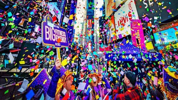 A crowd cheers as confetti rains down in Times Square for New Year's Eve