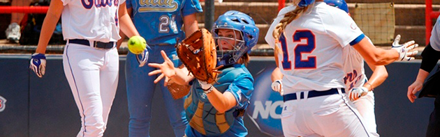 Image of a softball player catching an incoming ball.