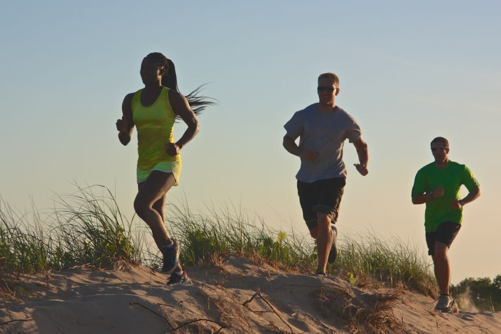 Athletes running on the beach