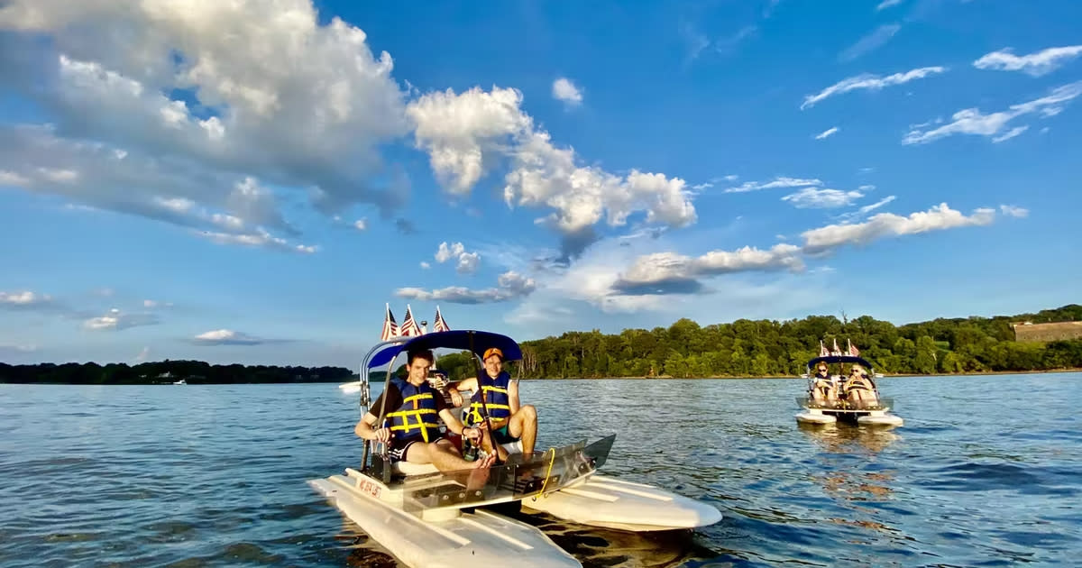 A group of people paddle a paddleboat in Prince George's County, Maryland