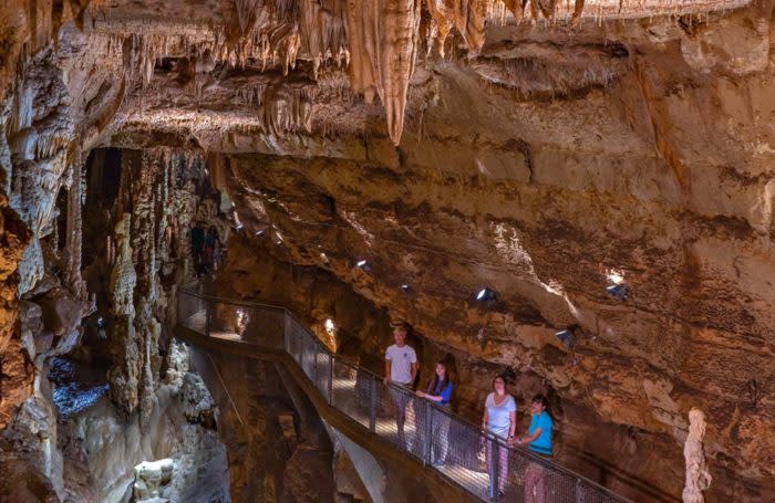 group of people looking at stalagmites