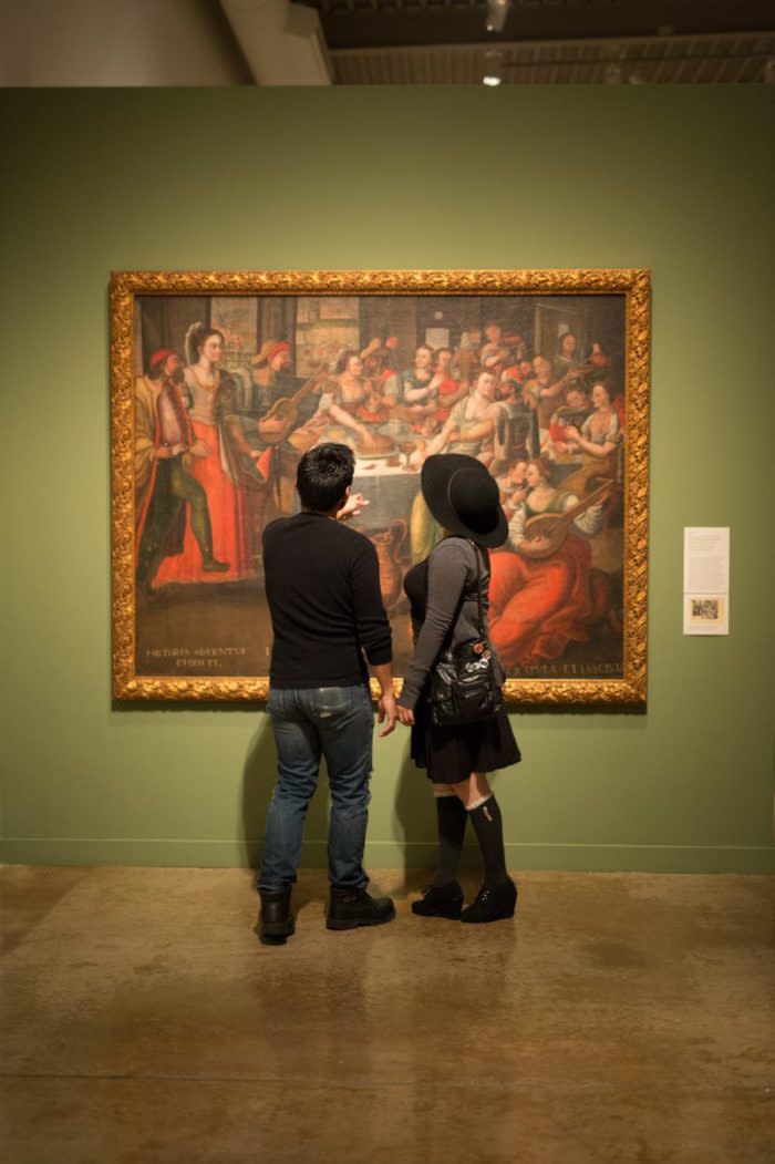 Couple viewing art on wall.