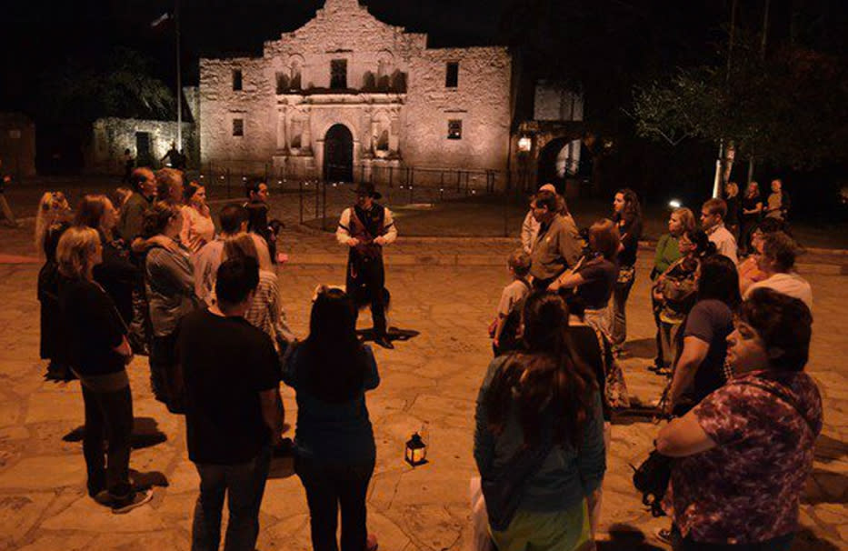 Group listening to tour guide in front of Alamo