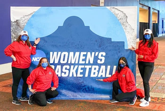 A group of people posing for a photo in front of a banner</p>
<p>Description automatically generated with medium confidence