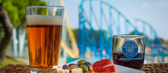 Glasses of Adult Beverages in front of Rollercoaster