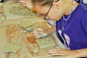 Everyone has a hand in creating a treasure with Family Clay Play. 