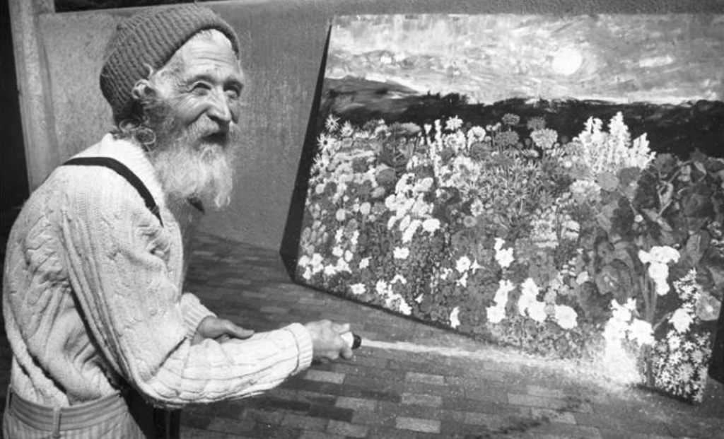 Tommy Macaione and one of his paintings. (Photo courtesy of Palace of the Governors Photo Archives Negative HP.2014.14.879)