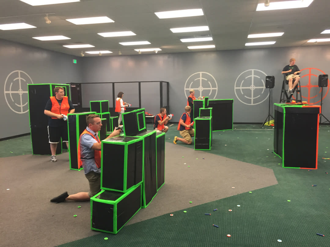 A group of young adults having a nerf gun war at Blaster Tag