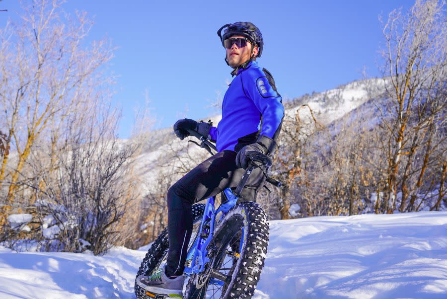 Man sits on fat tire bike on snowy path