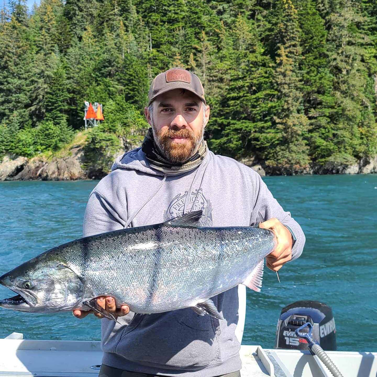 President Joe List in a boat with a nice sized salmon
