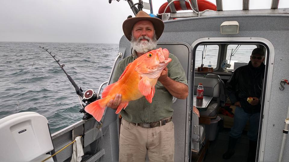 Board Member Bob Harden on a boat with a nice sized rockfish