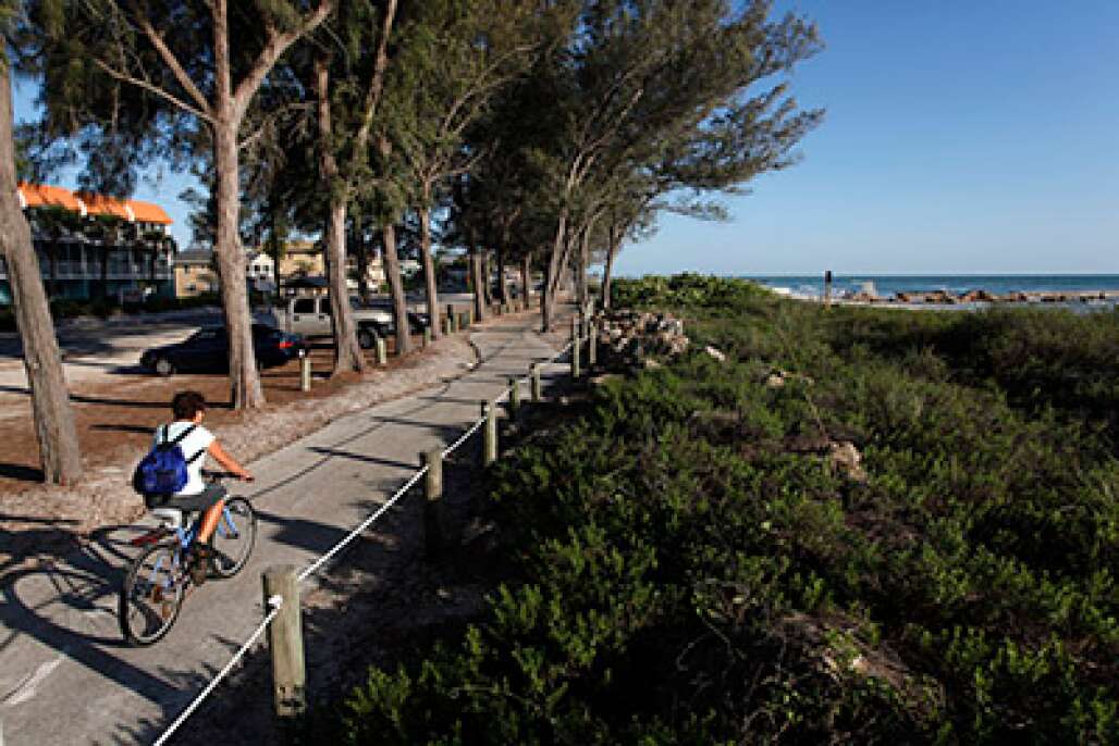 A cyclist rides along the Coquina Beach trail in Bradenton Beach, which has more than five miles of bike paths and bike lanes on Anna Maria Island on the Gulf of Mexico.