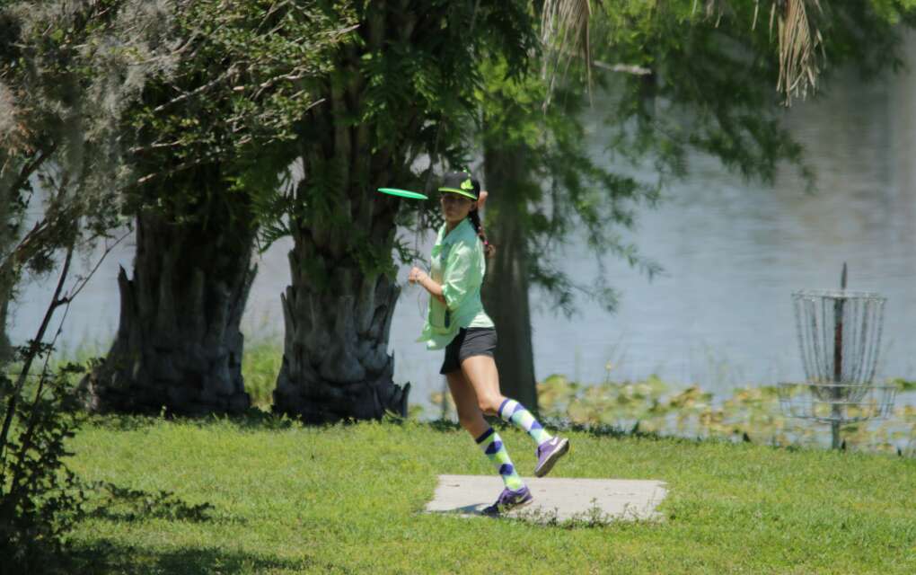 A young woman drives off of the tee box at Bill Frederick Park at Turkey Lake in Orlando.